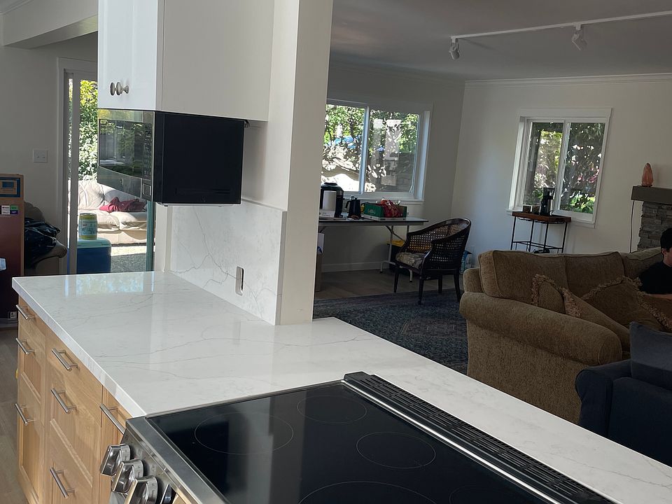 Open concept kitchen opens to great room and dining room with access to outside patio space
