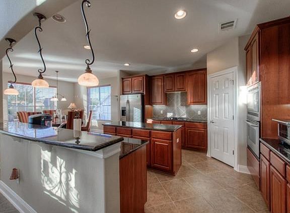 The chef in the family will feel right at home in this spacious kitchen with gas cooktop, stainless appliances, granite counters, center island and breakfast bar.