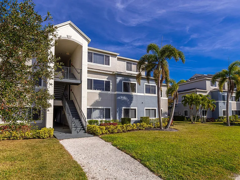 Lexington Palms offers a beautifully maintained community with walking paths, palm trees, and vibrant greenery.