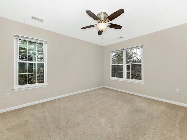 Primary bedroom off of living room, unstaged.