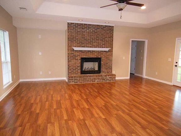 Large Family Room with Brick Fireplace and Vaulted Trey Ceiling