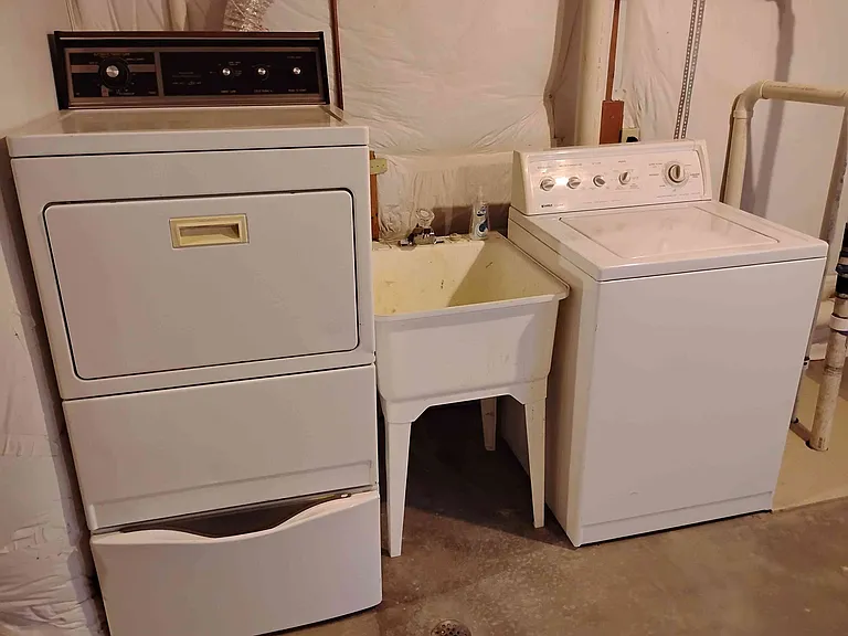 Washer, dryer and deep sink in basement. Also has new sump pump. This room is heated and insulated.