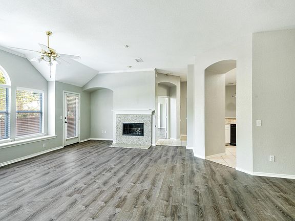 living room with granite fileplace, private yard and open patio