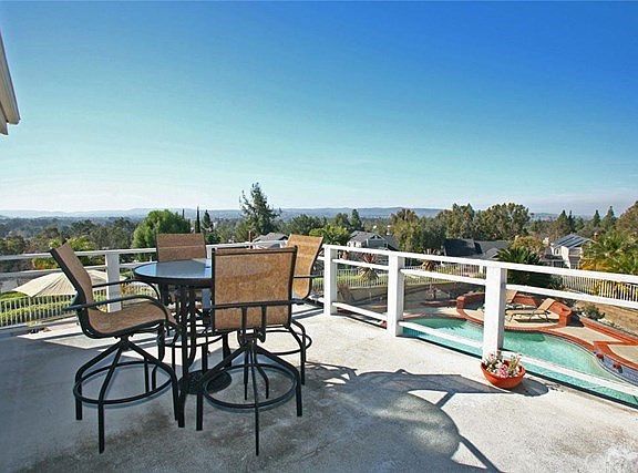 Deck off master bedroom with stairs down to yard.