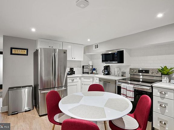 Newly updated kitchen, featuring new appliances: spacious refrigerator, microwave, dishwasher, and induction range and oven. Can come fully stocked with dishes/glasses, utensils, and cookware
