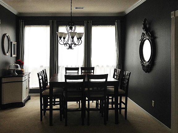 Formal Dining Room with designer paint, crown molding, and upgraded chandelier
