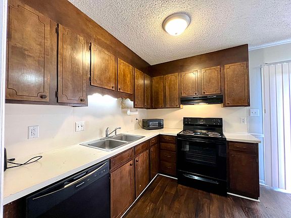 Kitchen includes: Top freezer/refrigerator, range, dishwasher, countertop microwave