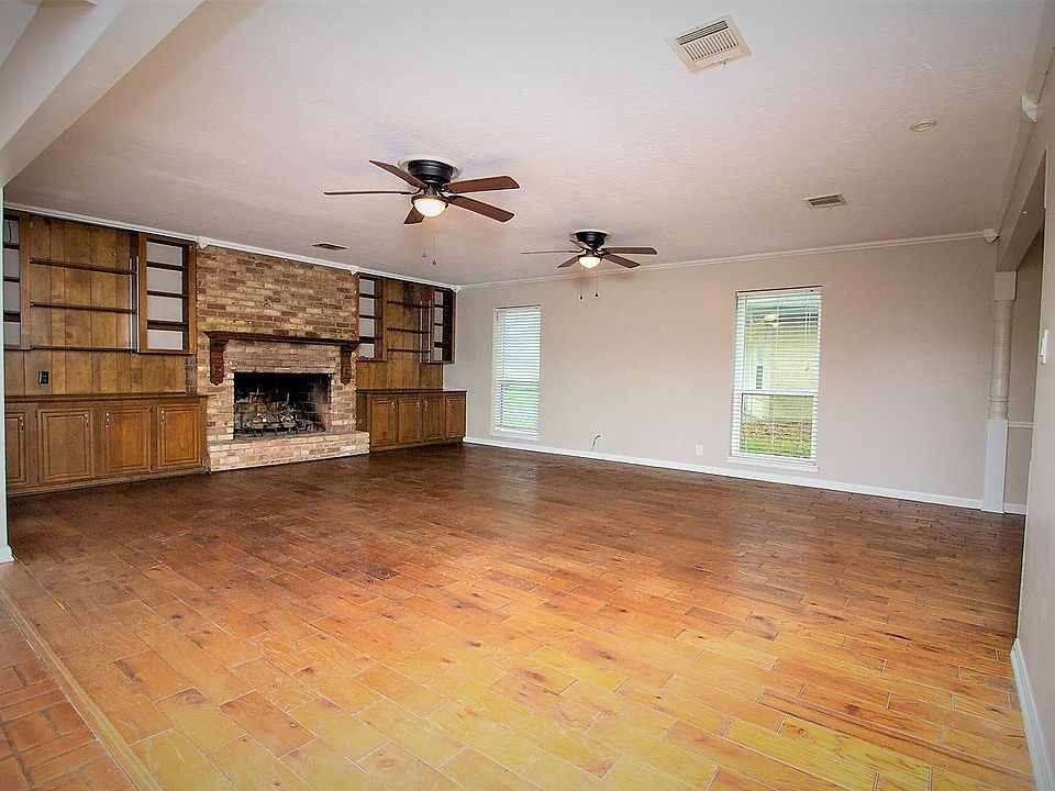 The spacious living room has original hardwood floors!