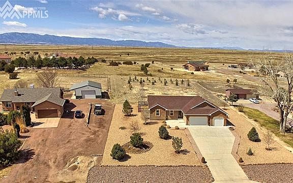 Serene location, extensive xeriscaping front & back with trees, grasses, & fenced rear lawn area.