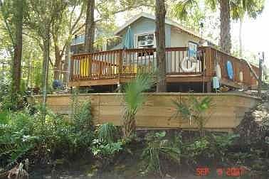 beautiful deck on the river with matching shed