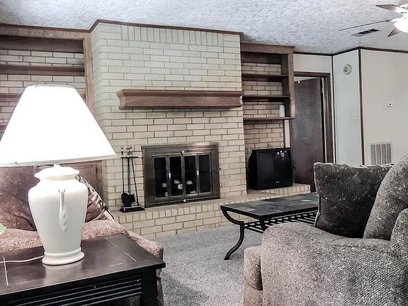Wood burning fireplace adds warmth to room.