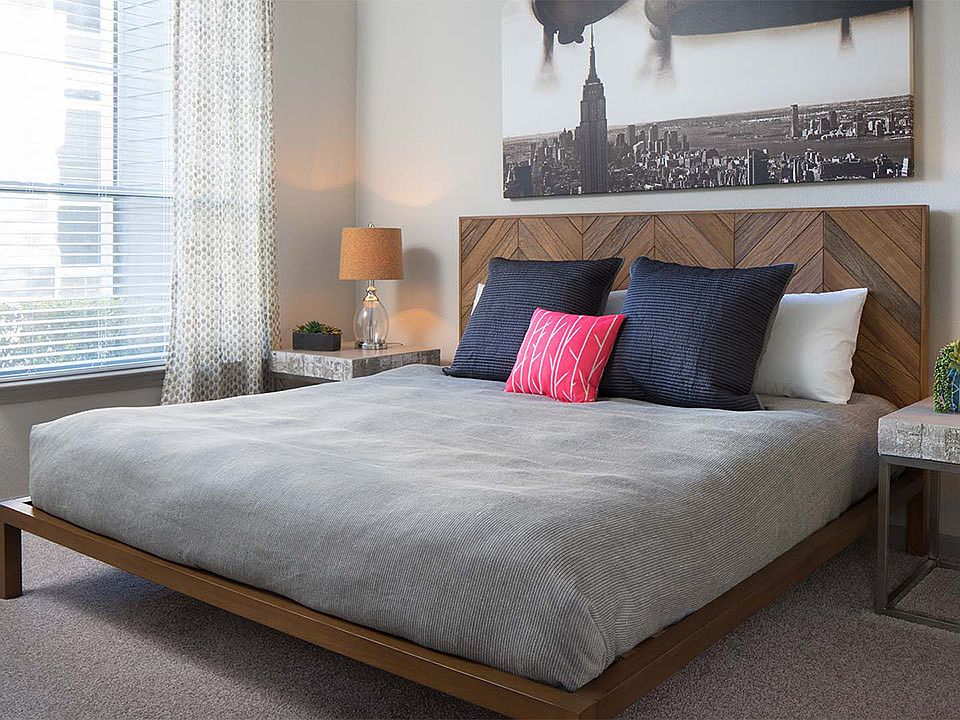 Spacious apartment bedroom with carpeted floors.
