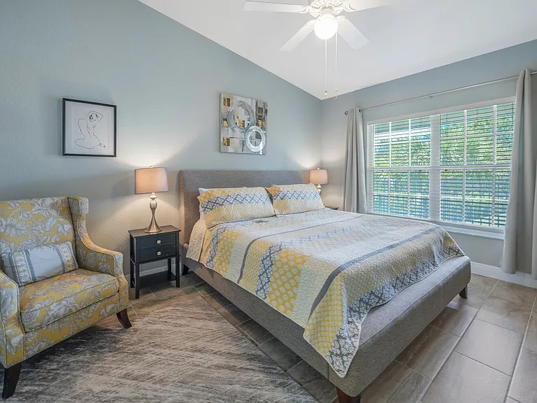 Master bedroom with king size bed, and smart TV (on opposite wall).