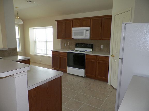 Great open kitchen to eat in area with window seat