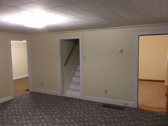 Nice living room with Berber carpet.Doorways go to dining room,upstairs and1st floor bedroom.