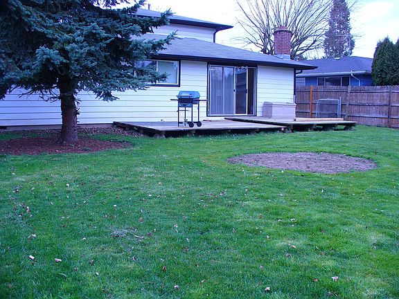 Big fenced backyard with deck