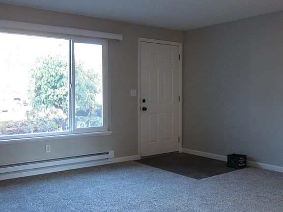 Sunny and extra spacious living room with tiled entry.
