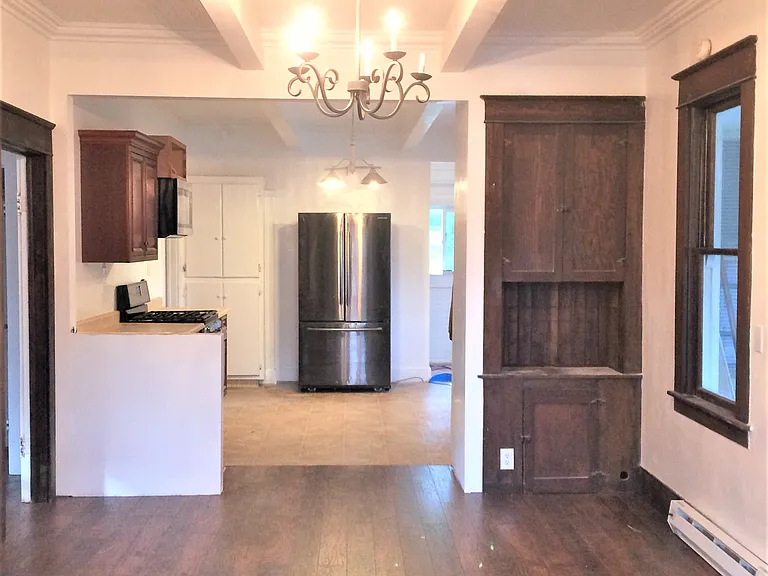 open concept living, original built-ins, coffered ceiling, spacious living room, beautiful floors