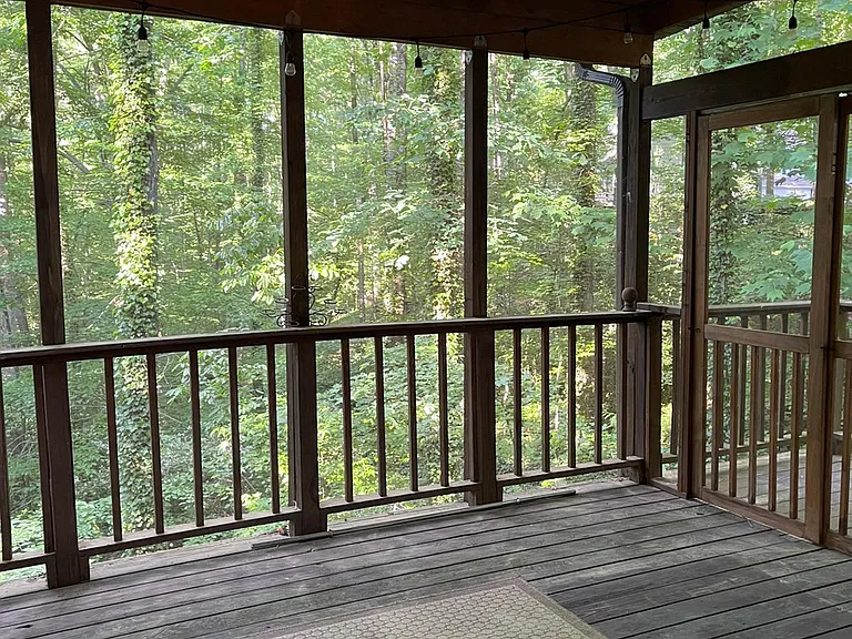 covered porch overlooking scenic backyard