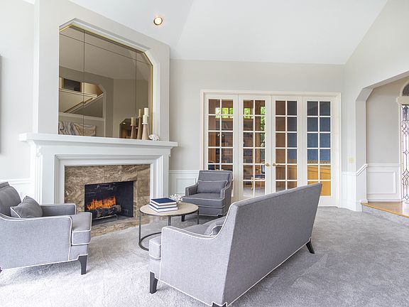 Light-filled living room with vaulted ceilings and gas f/p