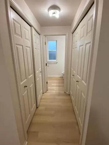 Hallway to full bath. Left is the washer/dryer closet. Right is linen/storage closet. - Meridian Ave N