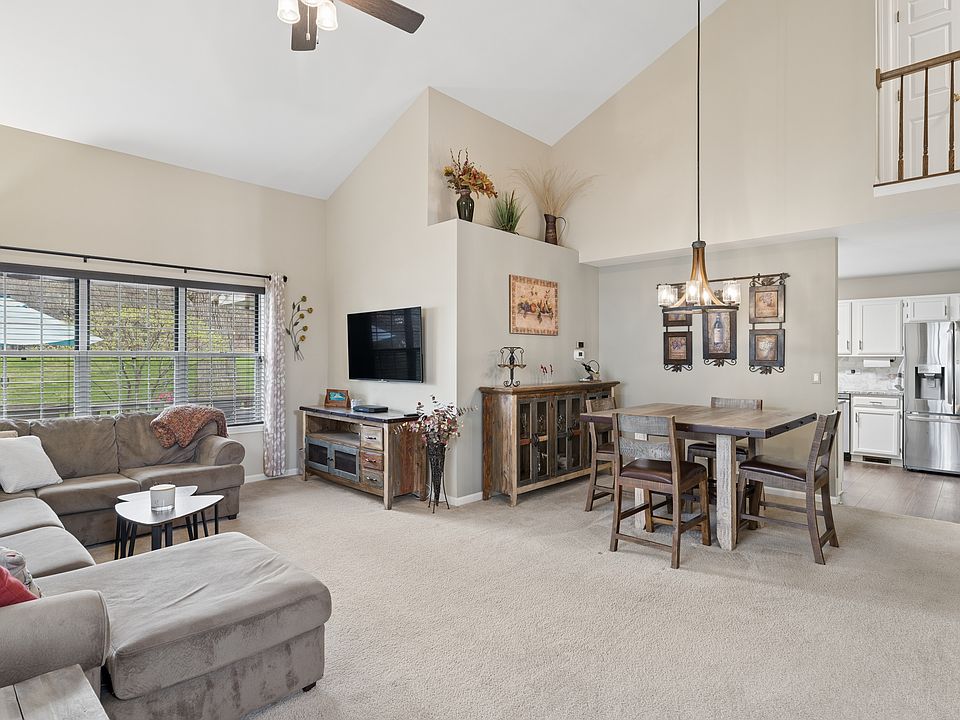 Open living and dining area with vaulted ceilings, large windows and plenty of natural light.