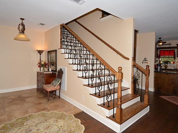 The wrought iron spindles and wood plank stair case are sure to impress your every guest.