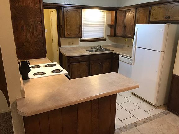 Kitchen with refrigerator, stove & dishwasher