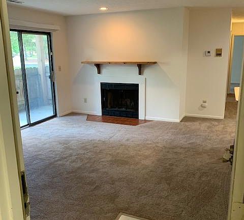 Walking in to 2163 C from the common hallway. Wood burning fireplace and sliding doors to the enclosed patio