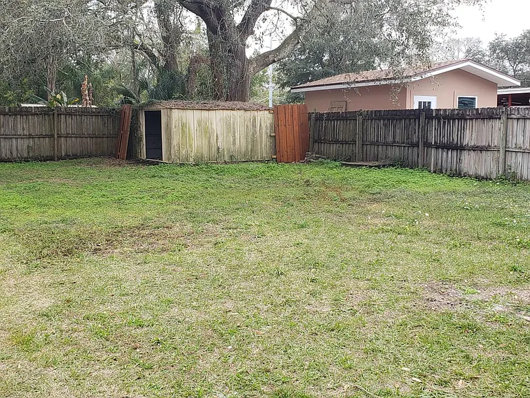 Large fenced in back yard with large shed in the back corner. This is second storage area.