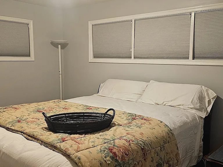 Deluxe California King bed with shared full bathroom