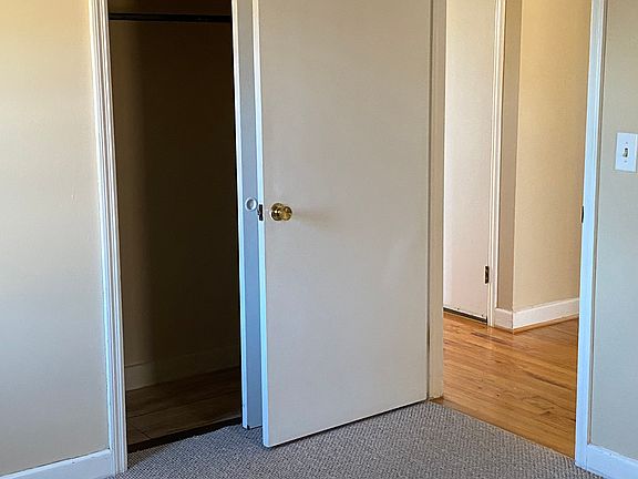 bedroom one closet, drapes/blackout shades, carpet