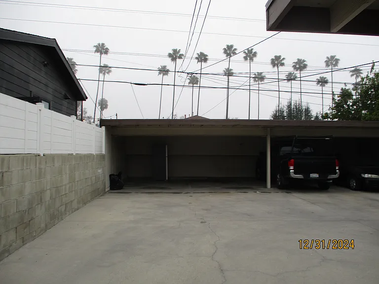 two parking car ports with storage bins behind