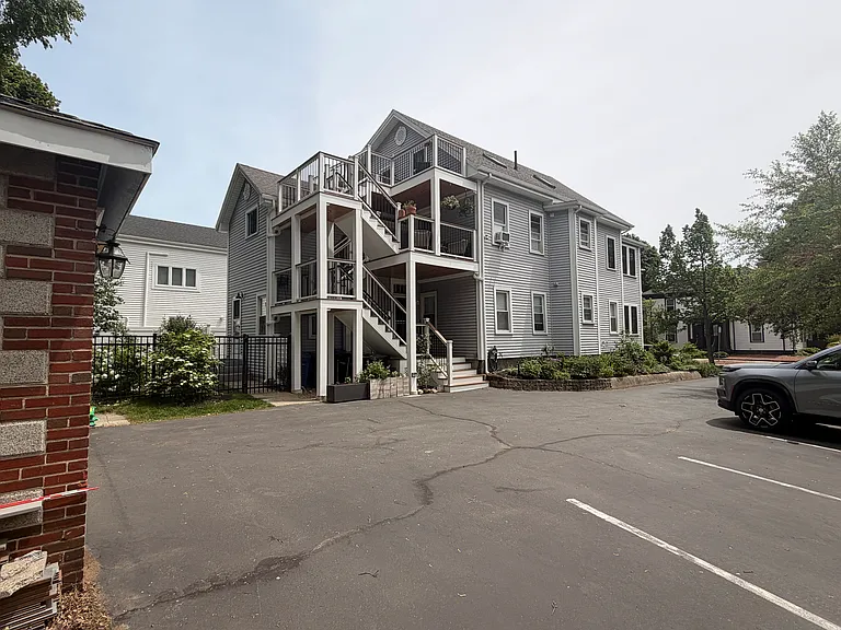 Parking area, and driveway-side entrance