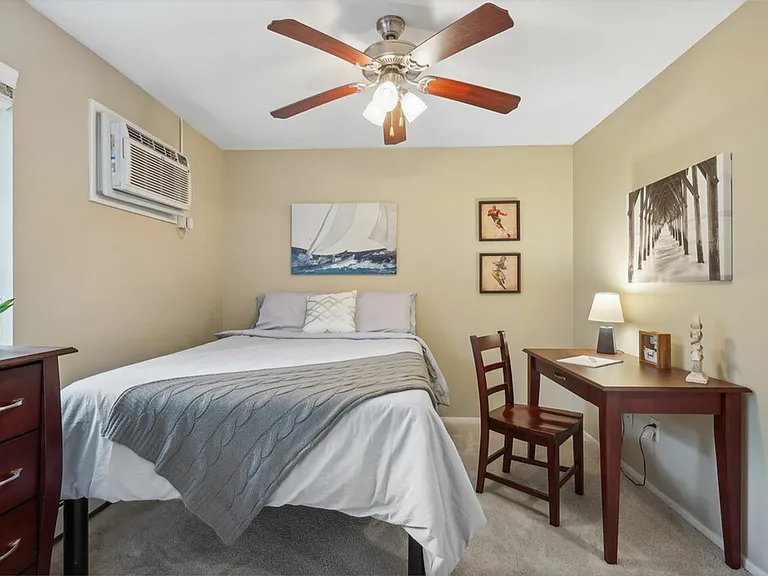 Relax in a comfortable and bright bedroom at University Oaks Apartments near Kent State University.