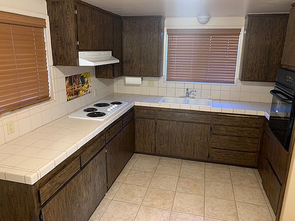 Kitchen with roll out drawers has all electric appliances.