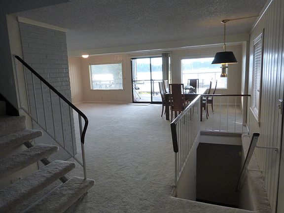 Living room with stairs to upper floor and stairs to lower f