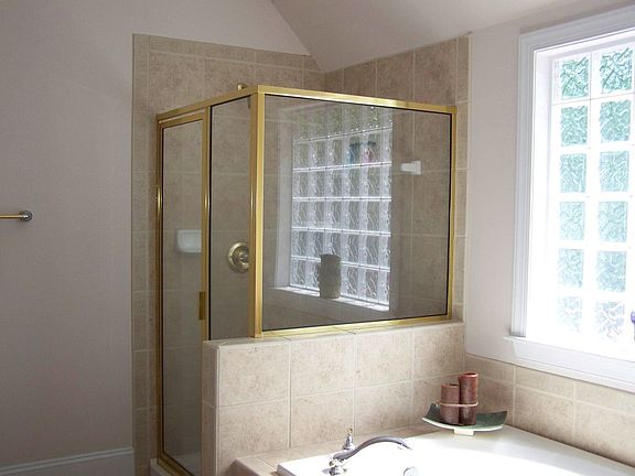 Master bath features jacuzzi tub, glass shower, ceramic tile and a double vani