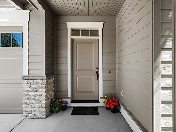 Front door; room for chairs and small table outdoors in front of kitchen to right