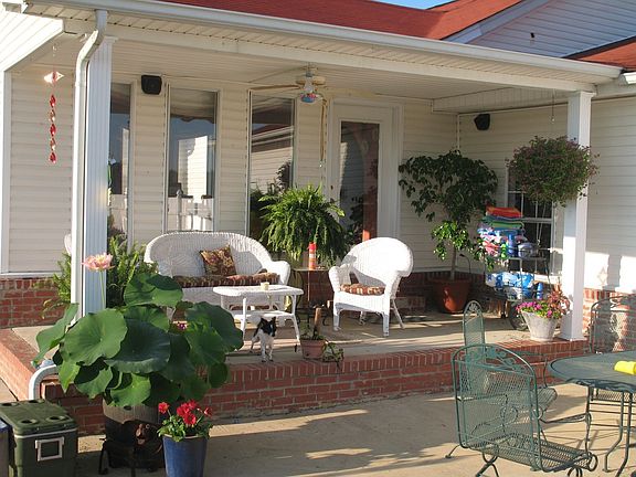 Covered back porch overlooking the patio and pool.  