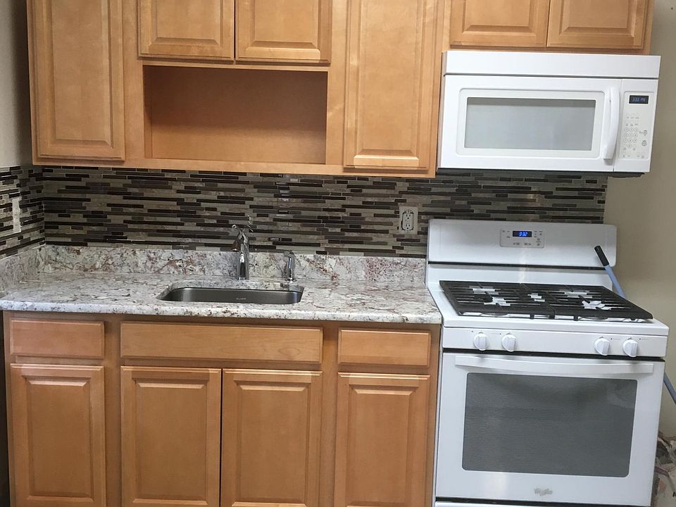 BRAND NEW KITCHEN CABINETS WITH GRANITE COUNTERTOP, KOHLER FAUCET AND ELECTRONIC GAS RANGE WITH BUILT-IN MICROWAVE