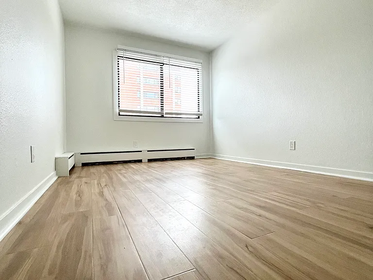 Bedroom with two tone lights, and plank blinds.