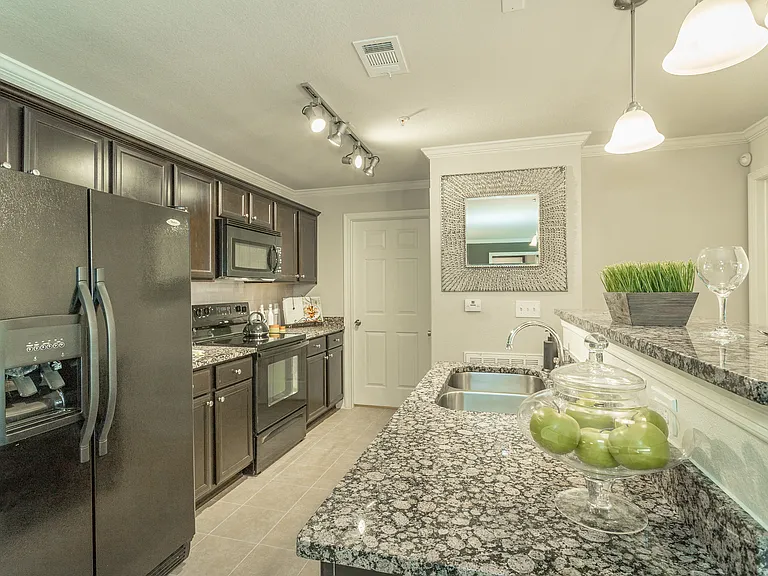Beautiful kitchen with black energy efficient appliances and granite countertops at Amberleigh Ridge