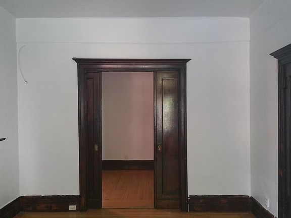Looking from Living Room through Pocket Doors to Middle Bedr