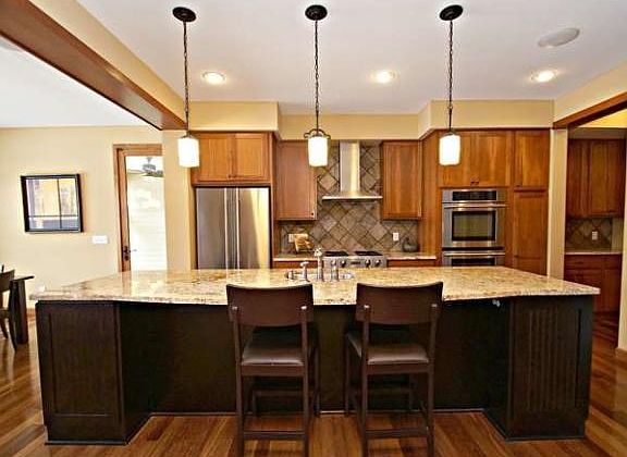 The huge, granite center island with sink is perfect for food prep, casual dining and gathering.