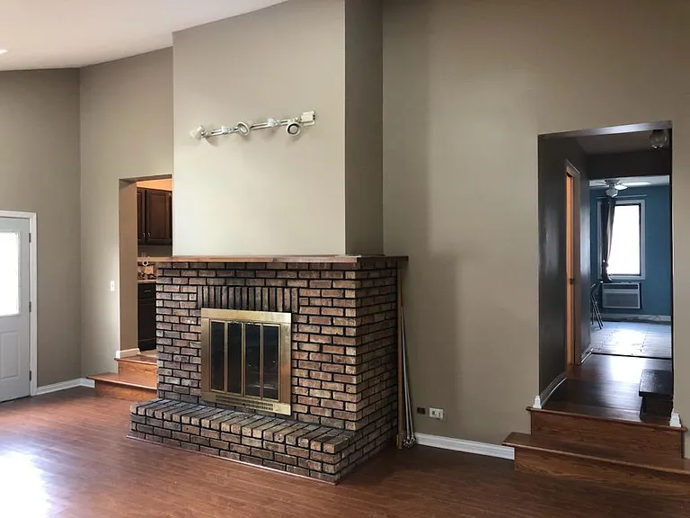 Large den with wood burning fireplace