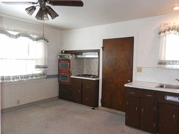 Kitchen has built-in stove, electric range & refrigerator