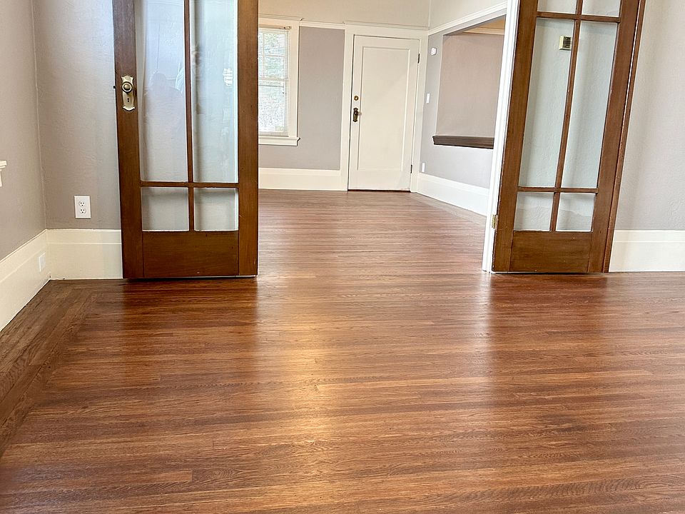 Standing in dining room looking toward living room and door to the balcony