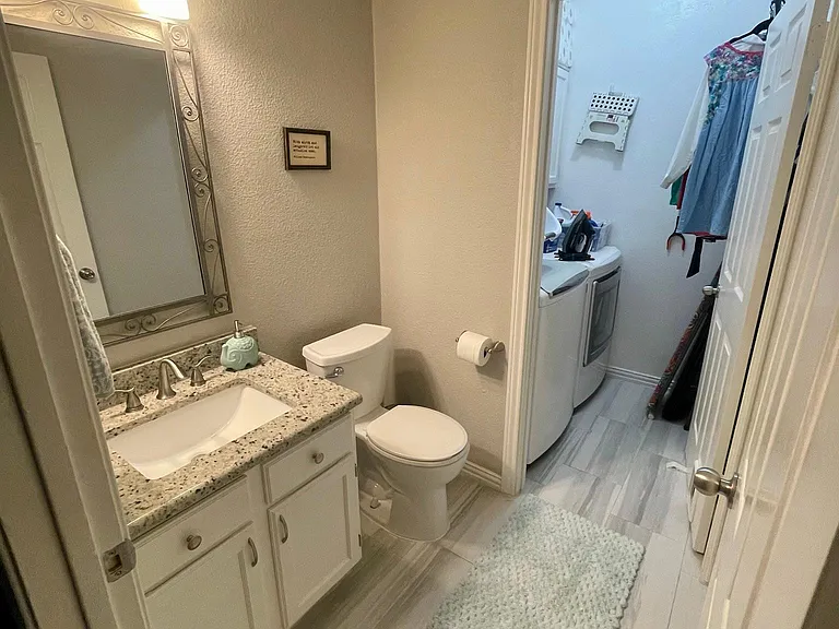 downstairs 1/2 bath, leads to laundry room