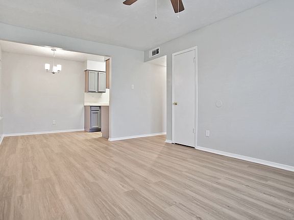 Spacious dining and living area with wood-style flooring